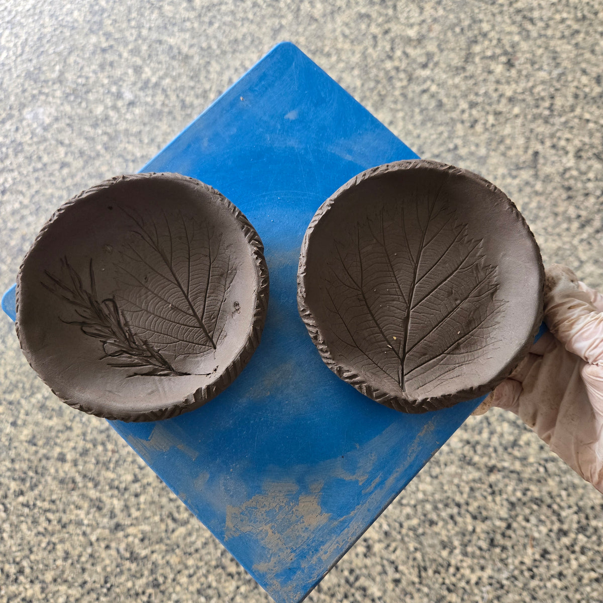 Handmade clay chess pieces from a pottery project